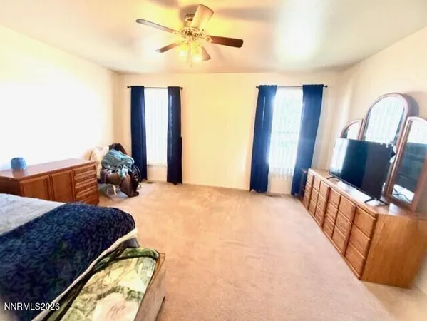 a bedroom with bed and wooden floor