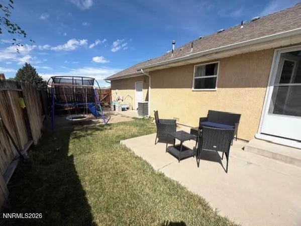 a view of a patio with table and chairs a barbeque with wooden fence