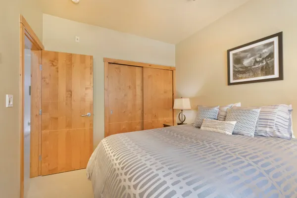 a bedroom with a large bed and a curtain