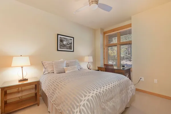 a bedroom with a bed and a night stand