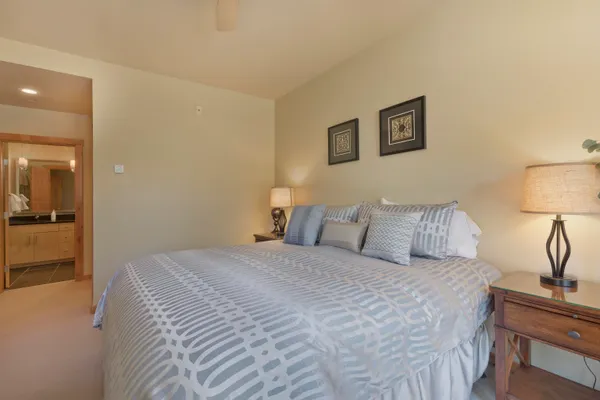 a bedroom with a bed and a lamp