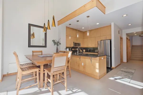 a kitchen with stainless steel appliances kitchen island granite countertop a refrigerator and a stove top oven