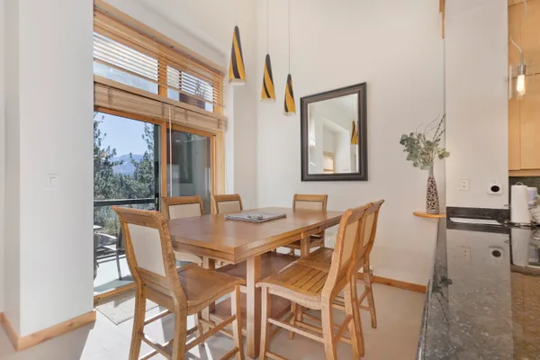 a view of a dining room with furniture and a window