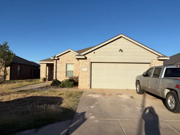 a view of a house with a car parked in front of it