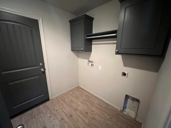 a view of a storage & utility room with wooden floor