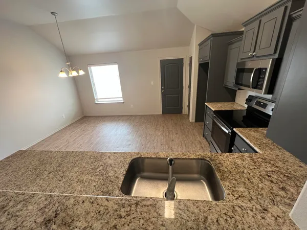 a kitchen with furniture and a window