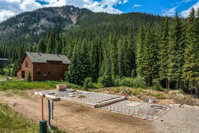 a view of a house with a yard and sitting area