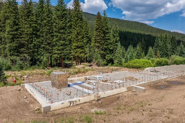 a view of a white house with a yard