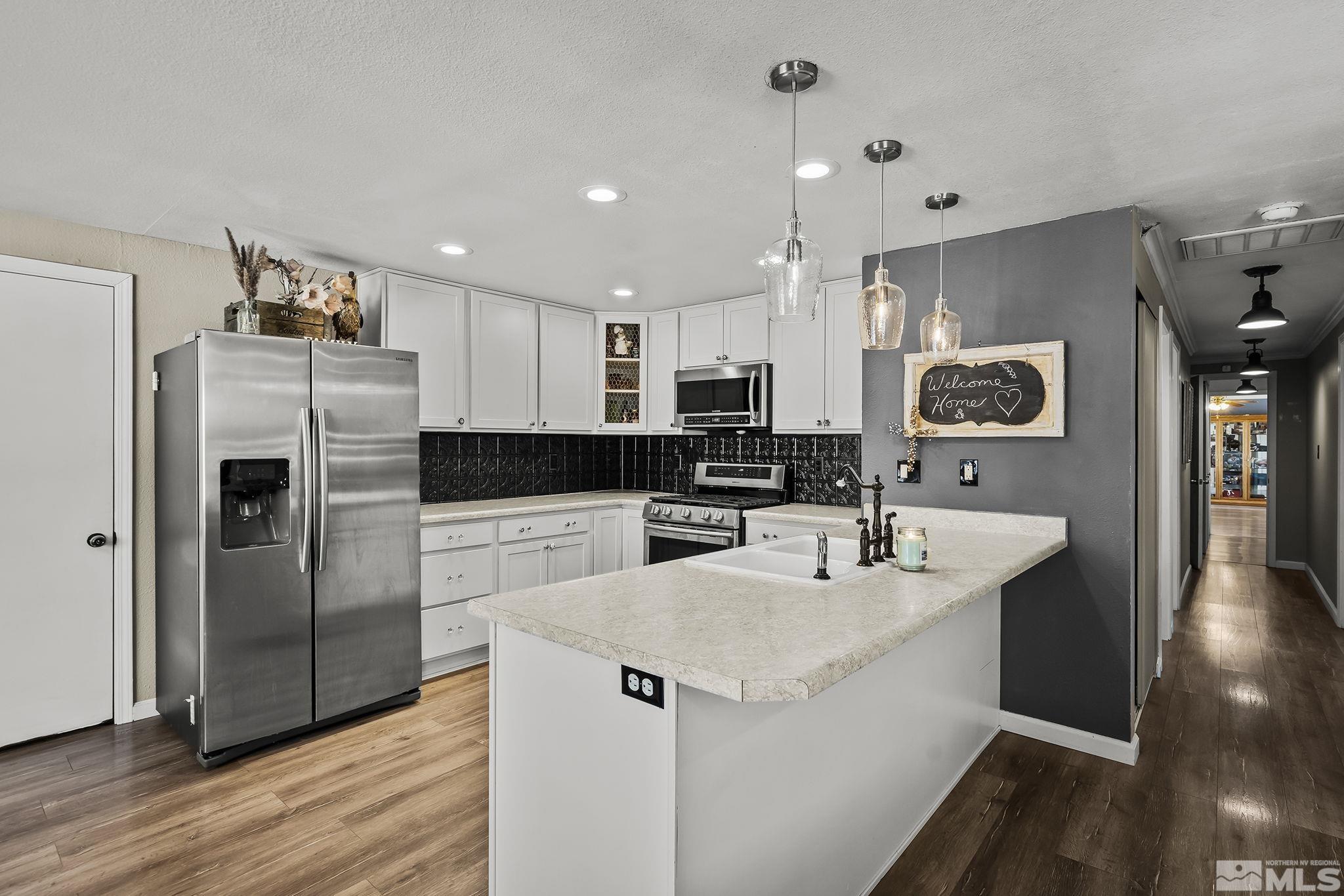 9525 Fremont Way Reno, NV 89506 - Photo 4 of 23 a kitchen with a refrigerator and a sink