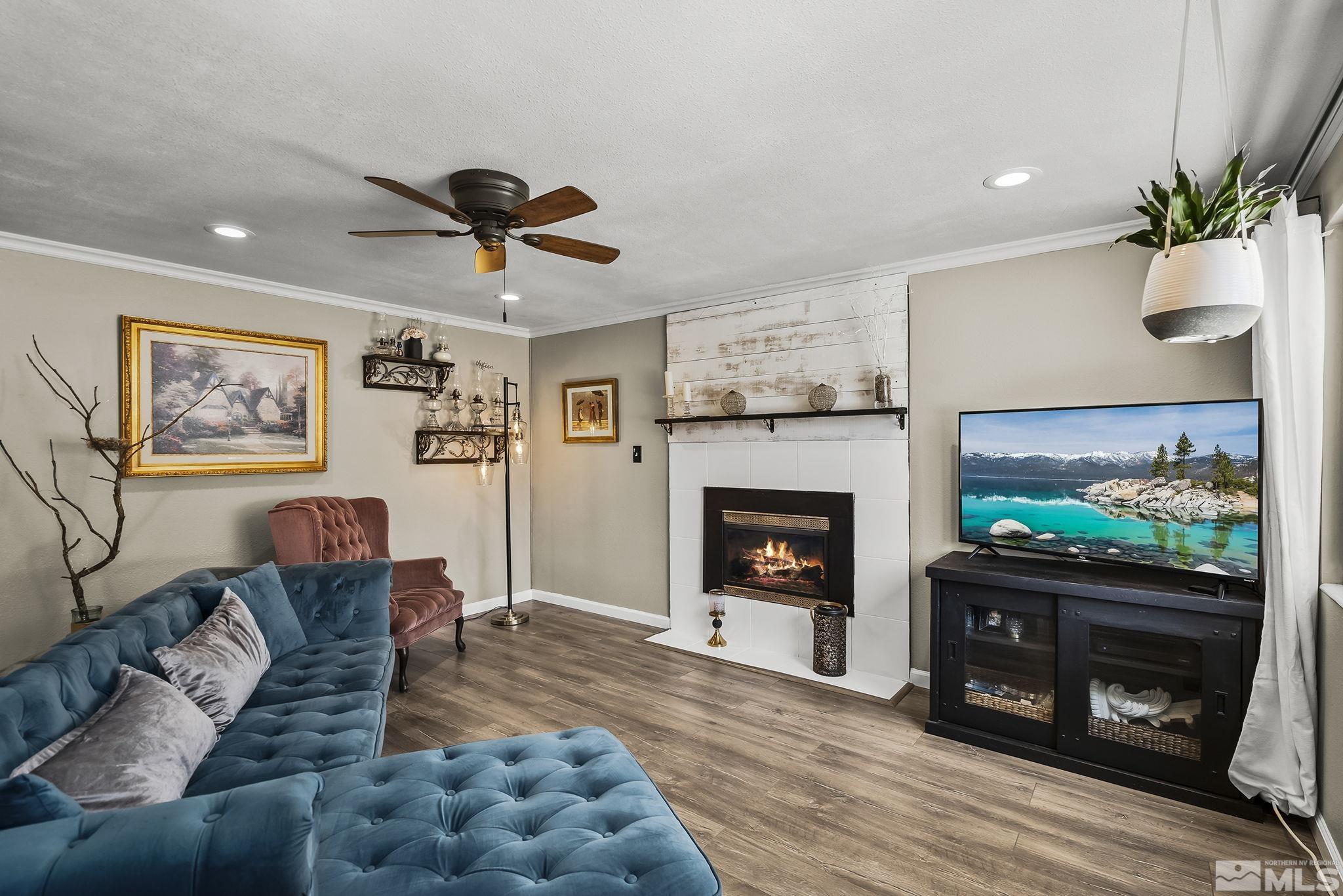 9525 Fremont Way Reno, NV 89506 - Photo 6 of 23 a living room with furniture a flat screen tv and a fireplace