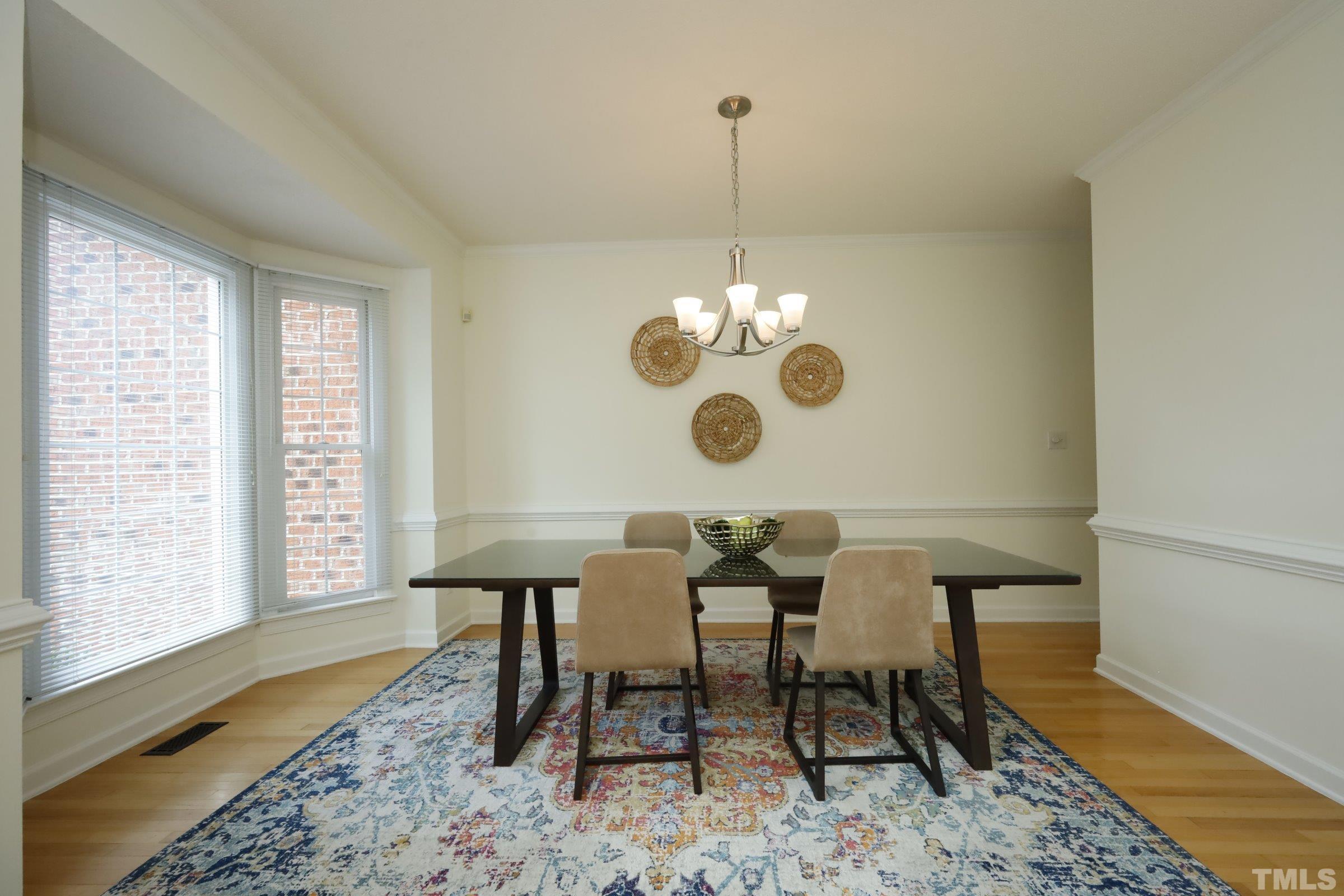 101 Modena Drive Cary, NC 27513 - Photo 11 of 57 a view of a dining room and chandelier in the back
