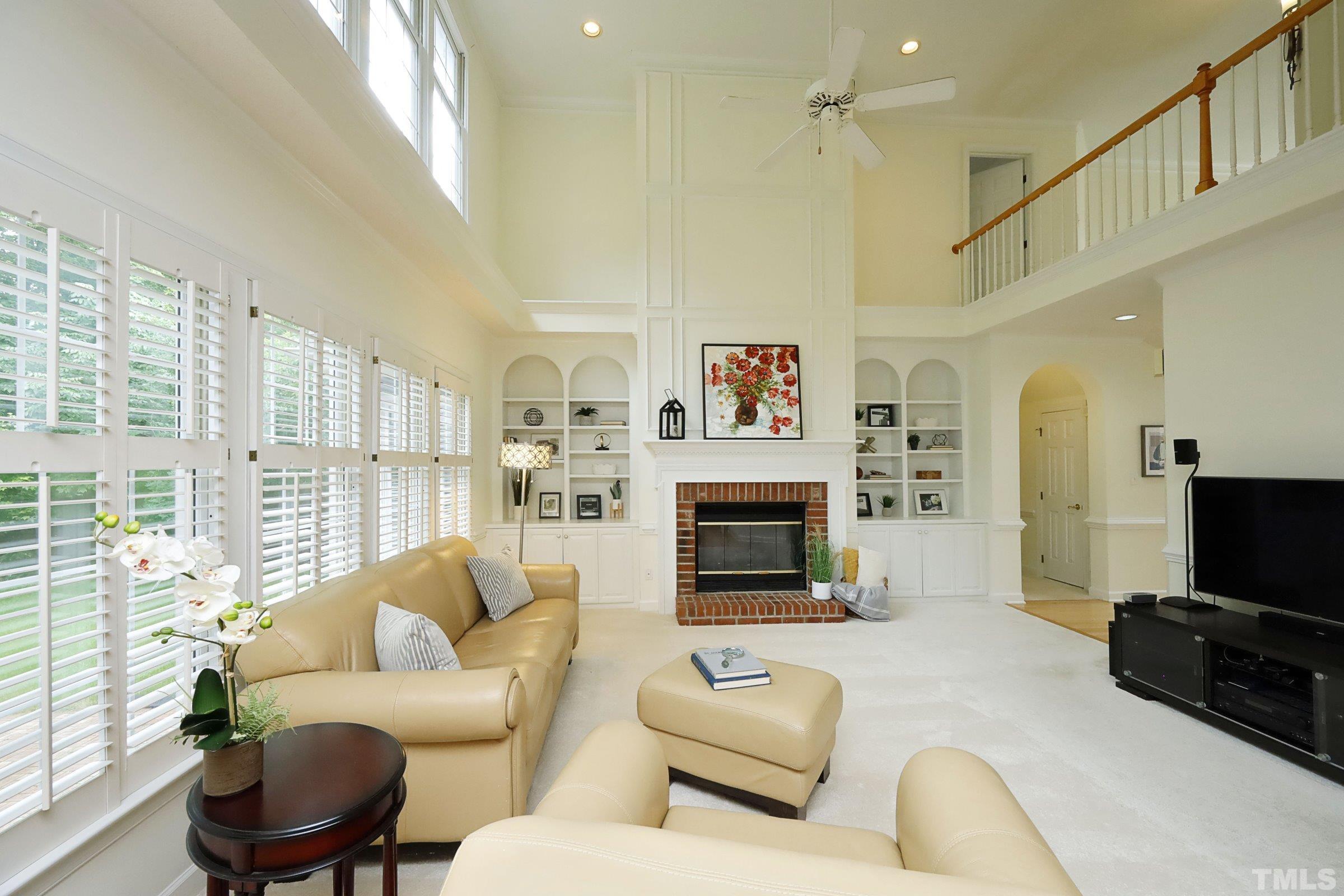 101 Modena Drive Cary, NC 27513 - Photo 13 of 57 a living room with furniture a flat screen tv and a fireplace