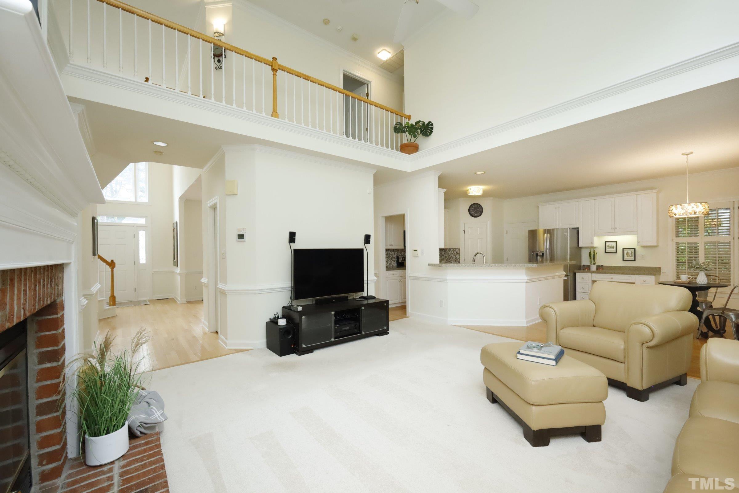 101 Modena Drive Cary, NC 27513 - Photo 15 of 57 a view of living room kitchen with furniture and a flat screen tv