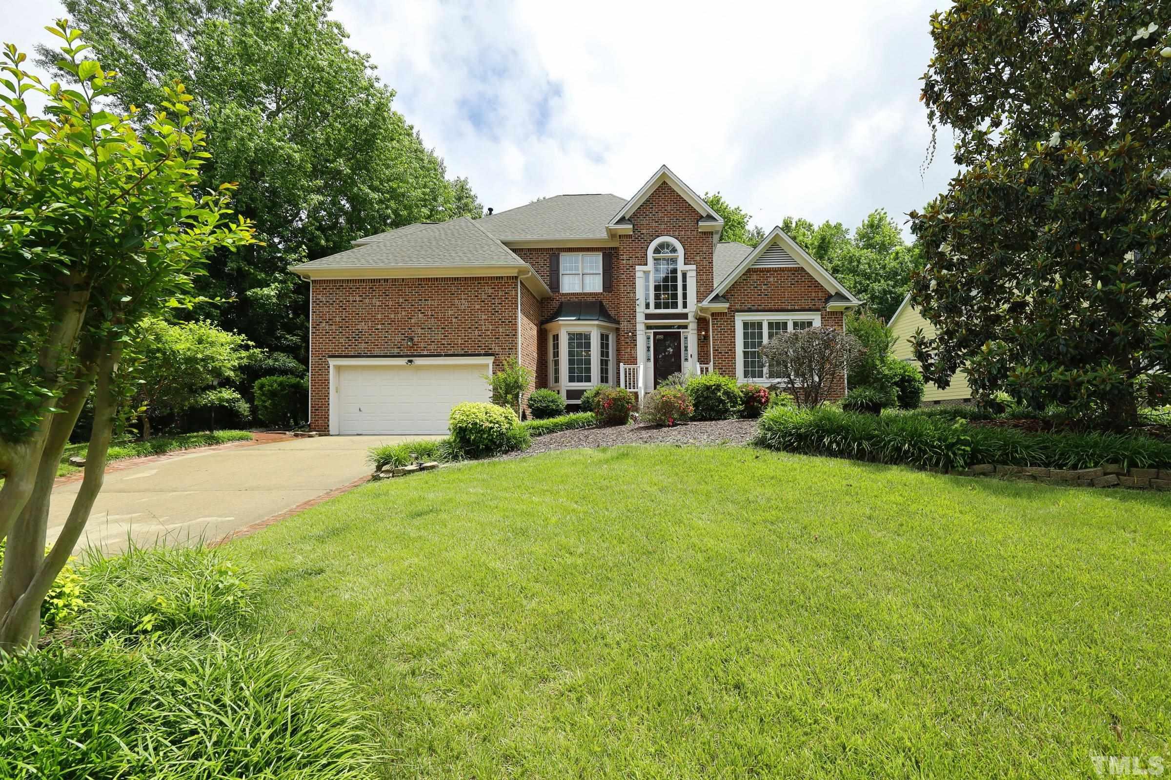 101 Modena Drive Cary, NC 27513 - Photo 2 of 57 a front view of a house with a garden