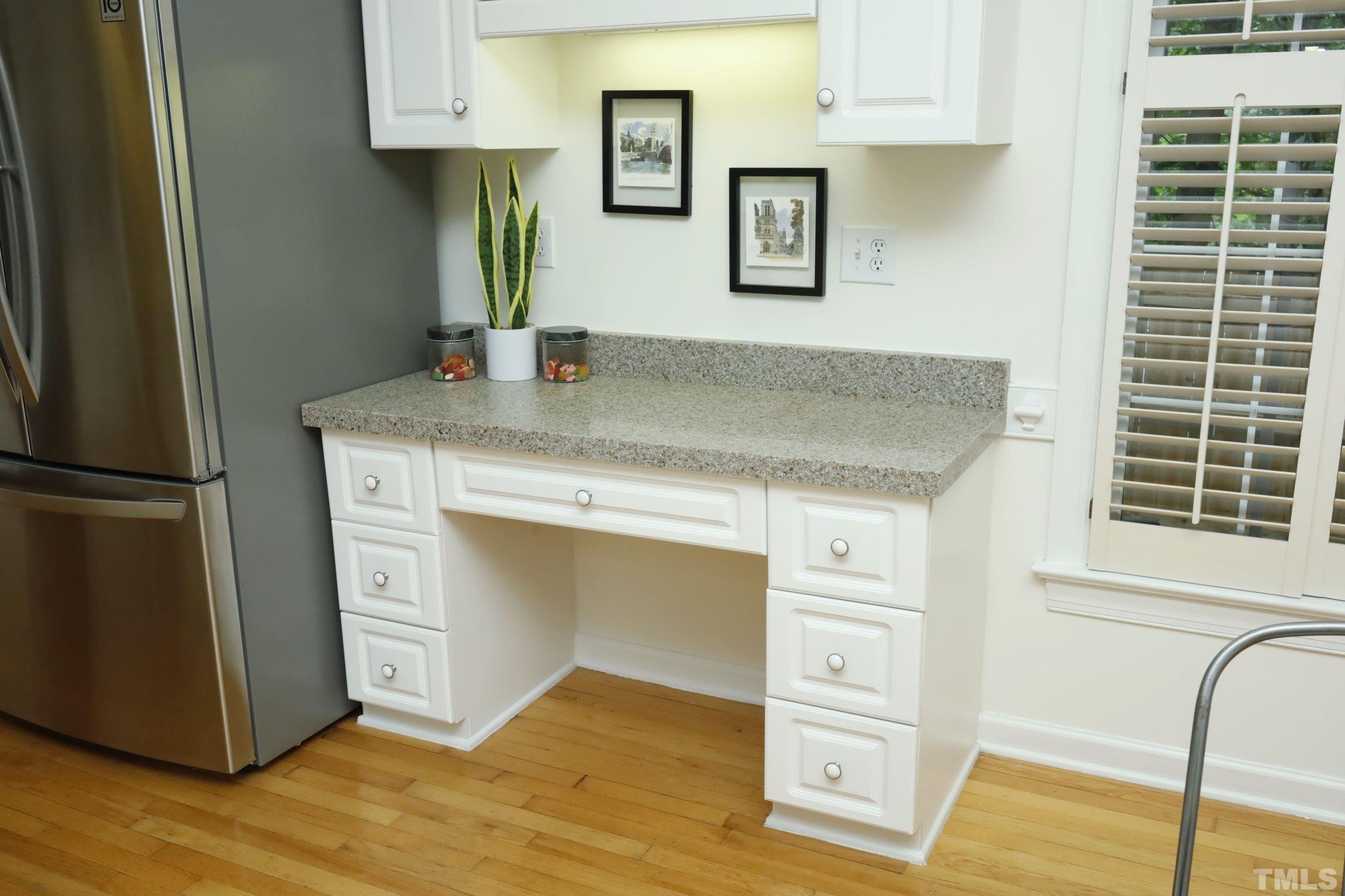 101 Modena Drive Cary, NC 27513 - Photo 24 of 57 a kitchen with cabinets and wooden floor
