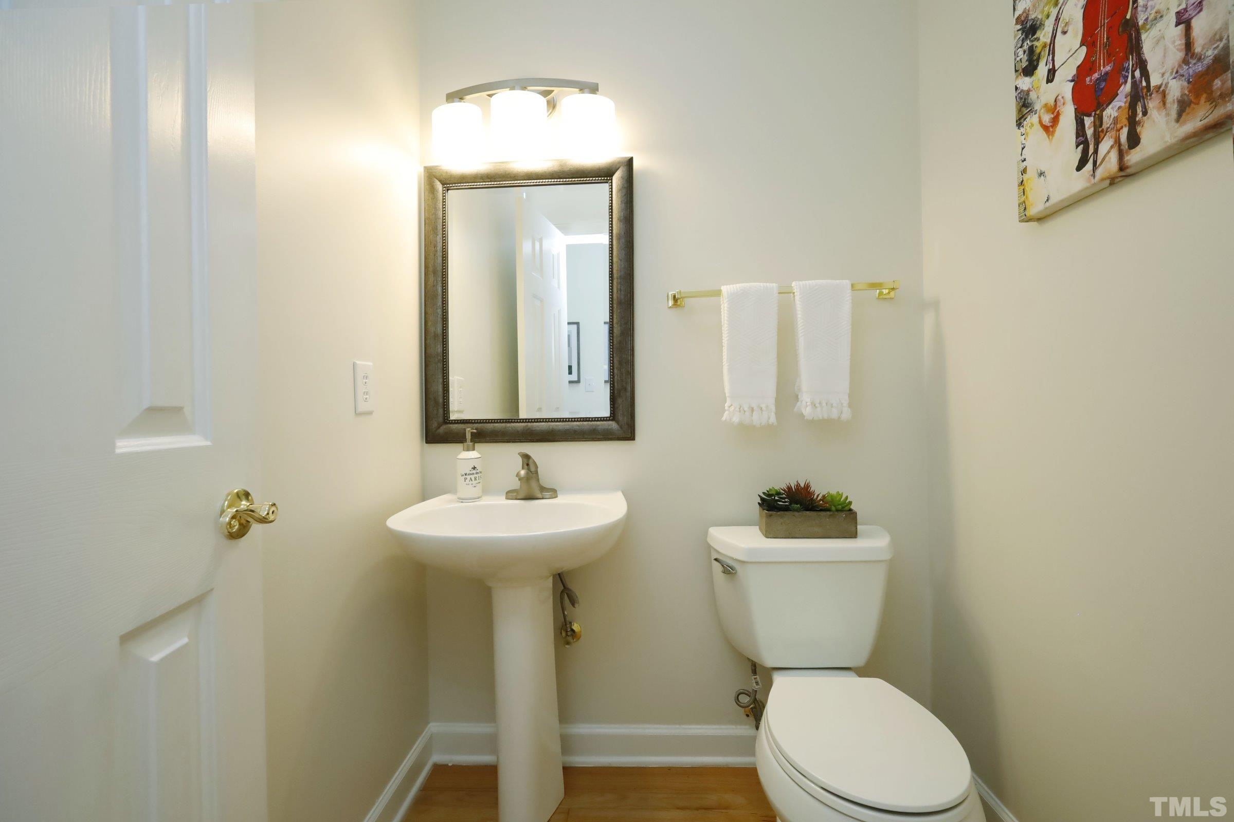 101 Modena Drive Cary, NC 27513 - Photo 27 of 57 a bathroom with a toilet sink and mirror