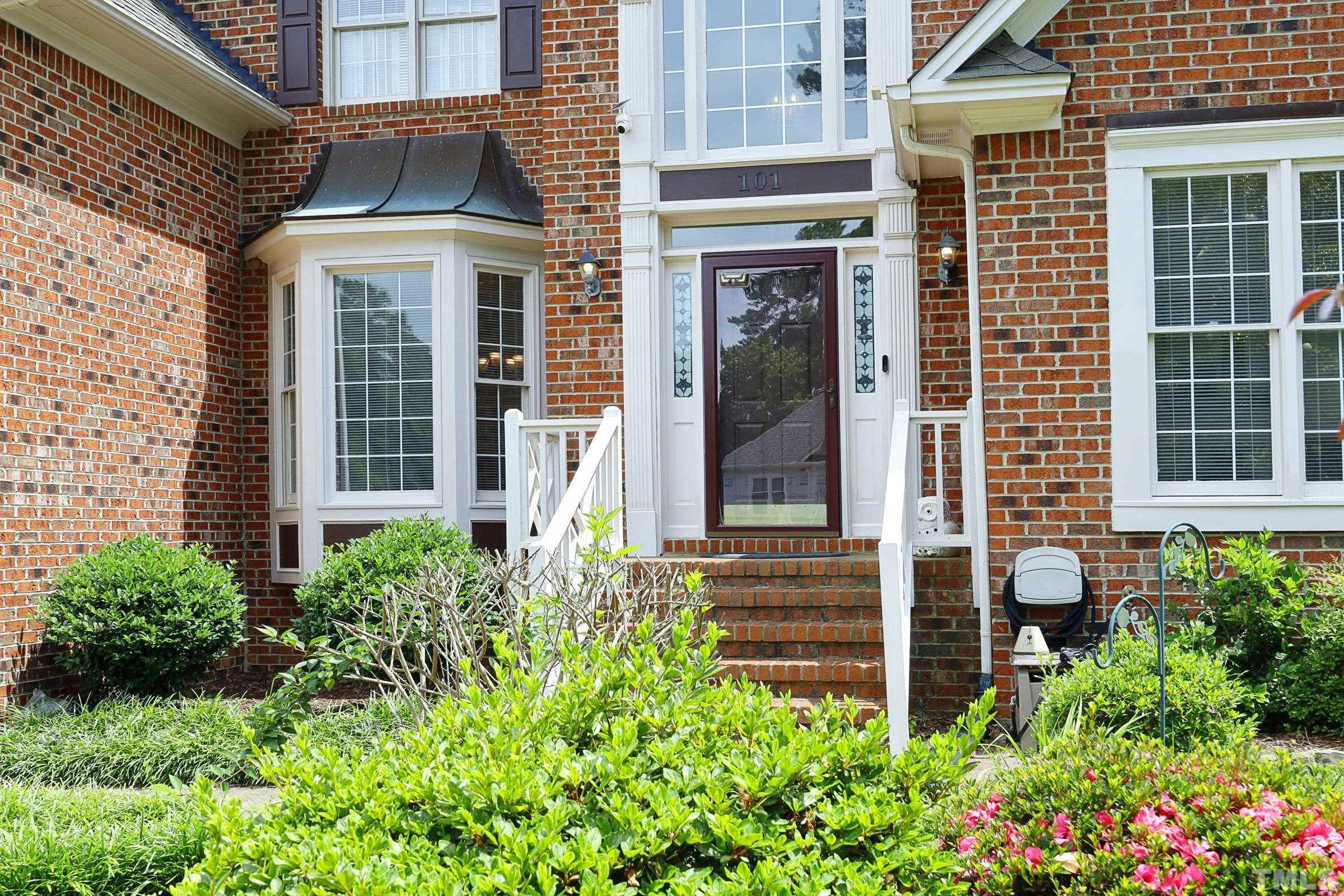 101 Modena Drive Cary, NC 27513 - Photo 3 of 57 a view of a house with potted plants and a large window