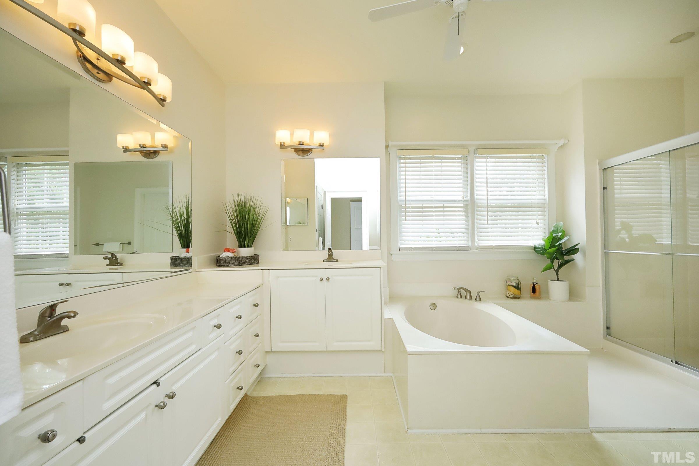 101 Modena Drive Cary, NC 27513 - Photo 31 of 57 a bathroom with a tub a sink and mirror