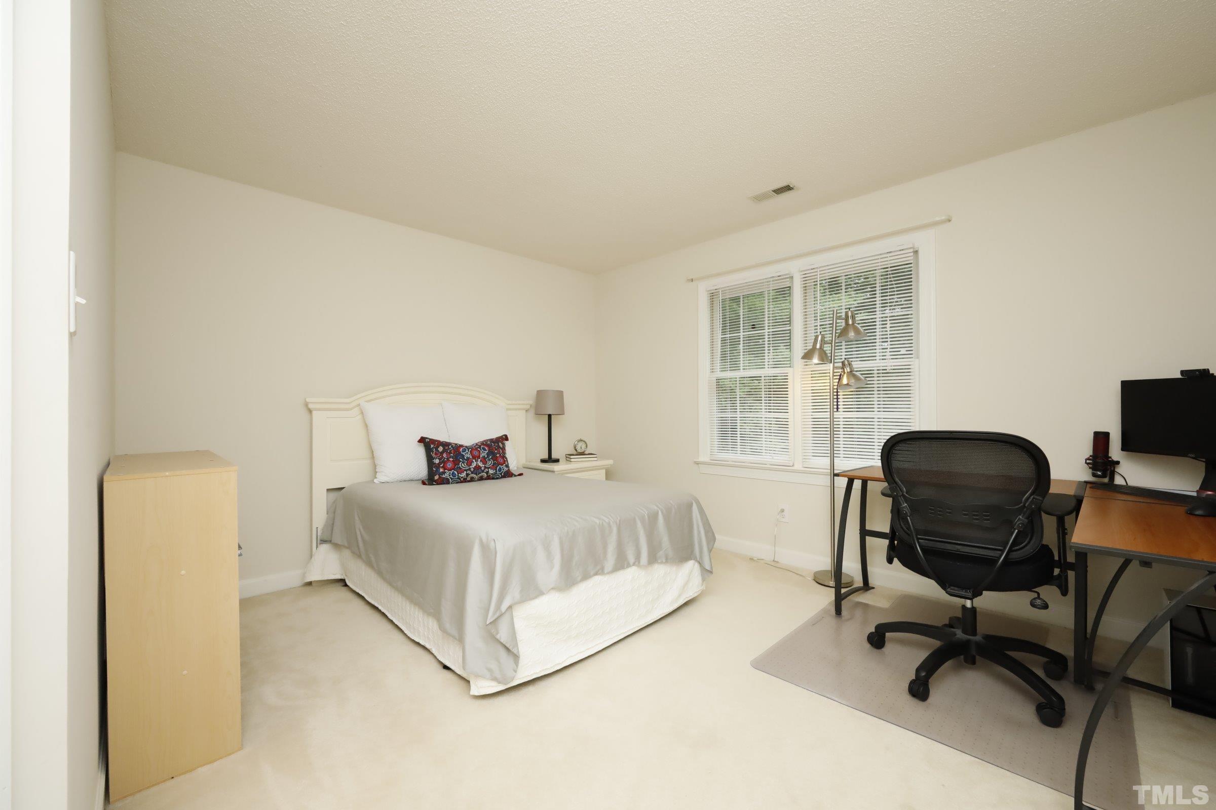 101 Modena Drive Cary, NC 27513 - Photo 37 of 57 a bedroom with a bed and a desk