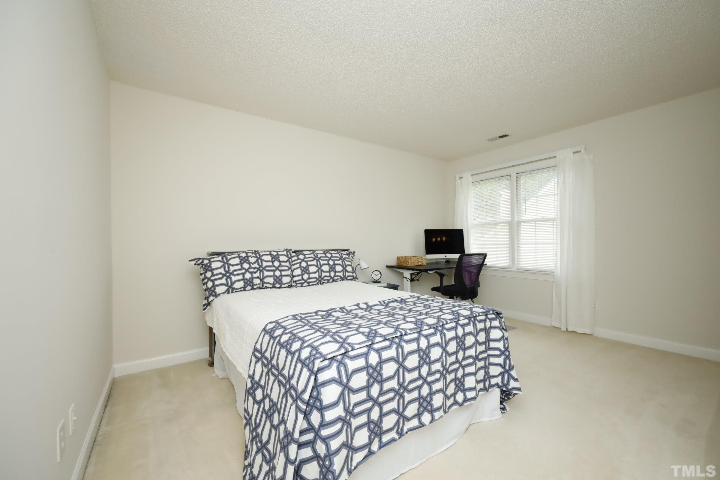 101 Modena Drive Cary, NC 27513 - Photo 39 of 57 a bedroom with a bed and chair