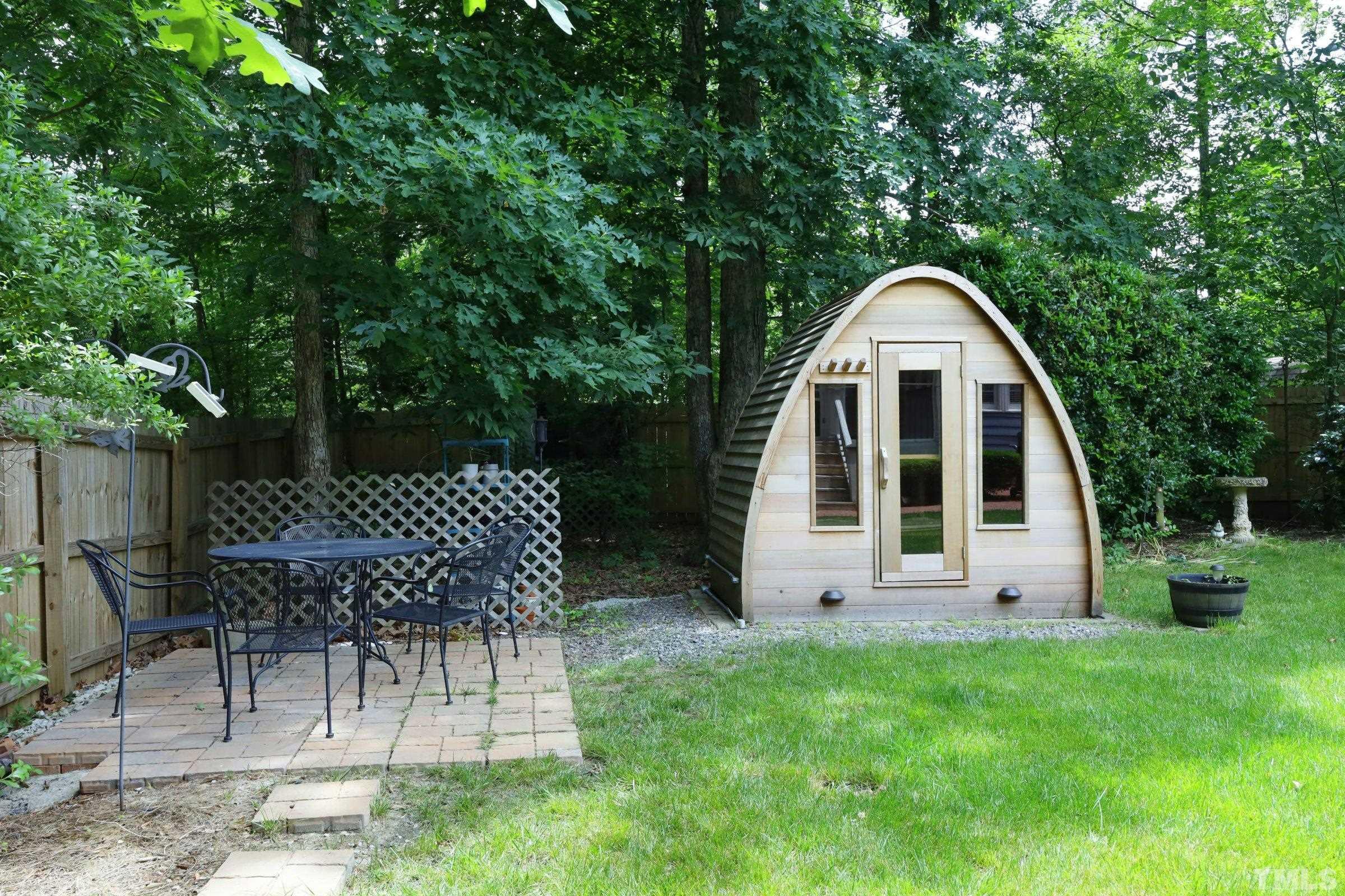 101 Modena Drive Cary, NC 27513 - Photo 46 of 57 a view of a chair and table in backyard of the house