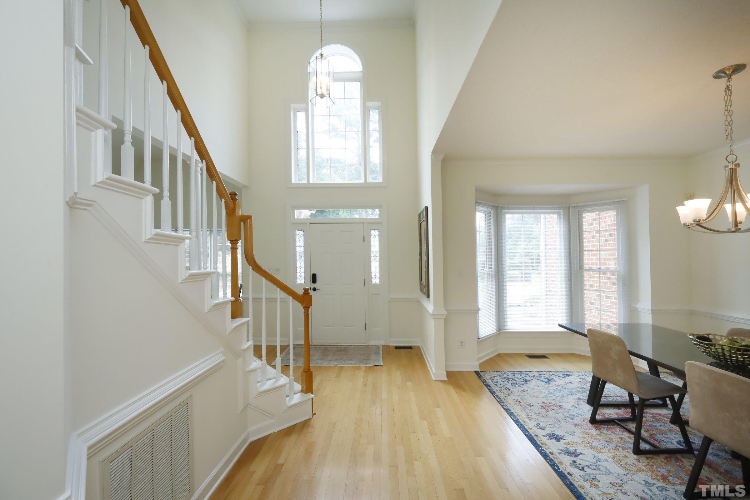 101 Modena Drive Cary, NC 27513 - Photo 5 of 57 a view of a livingroom with wooden floor and stairs