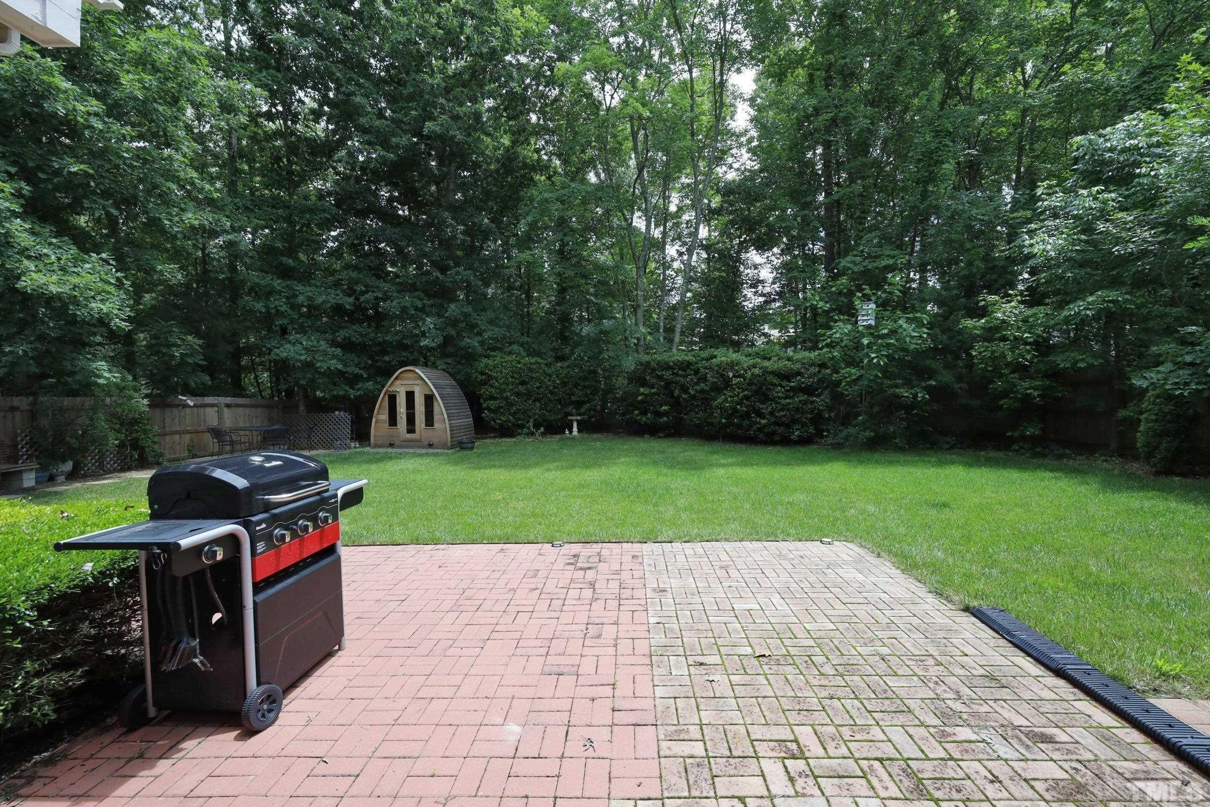101 Modena Drive Cary, NC 27513 - Photo 51 of 57 a green field with trees in the background