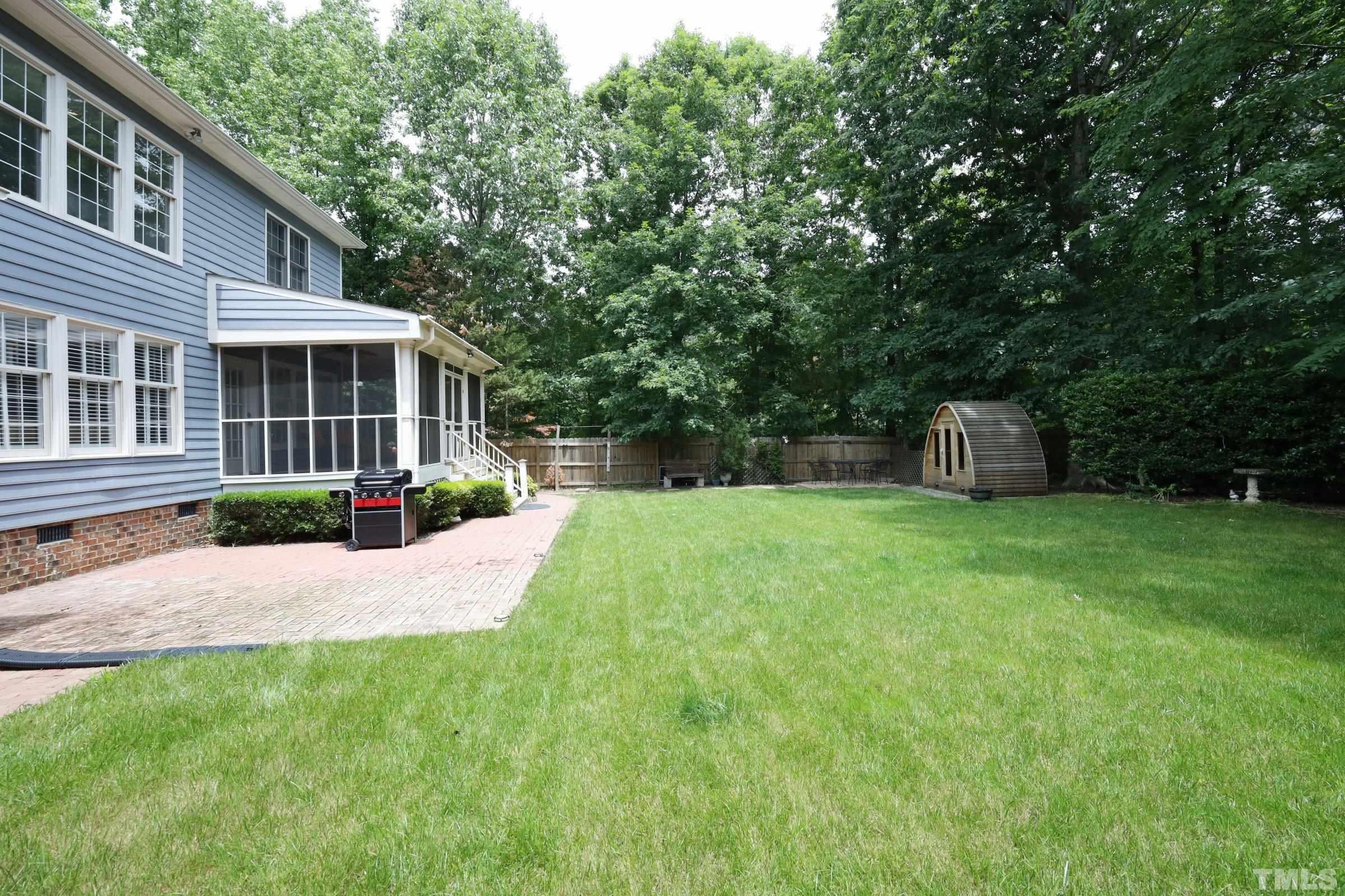 101 Modena Drive Cary, NC 27513 - Photo 52 of 57 a view of a house with backyard and a garden