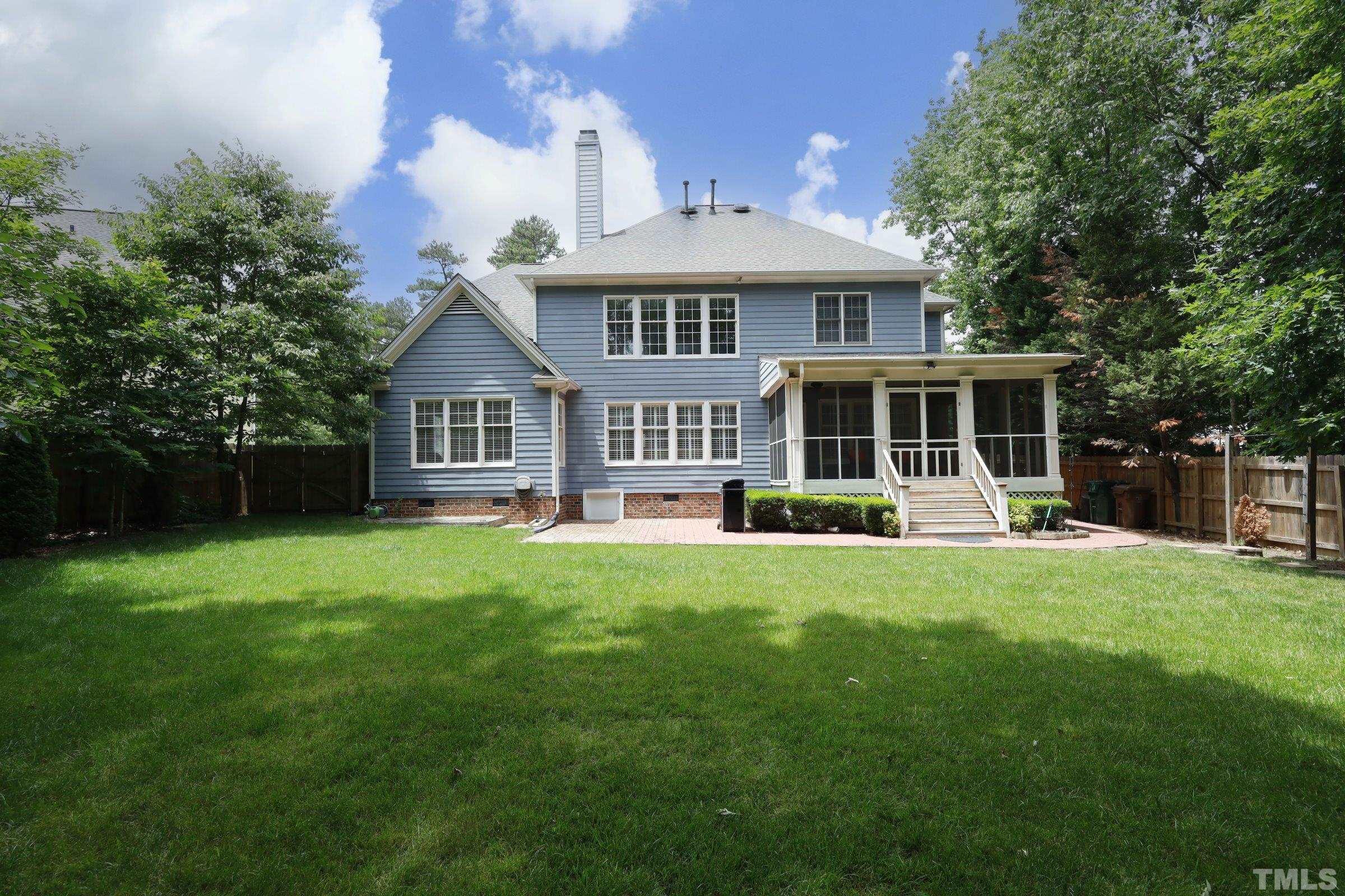 101 Modena Drive Cary, NC 27513 - Photo 54 of 57 a front view of a house with a yard table and chairs