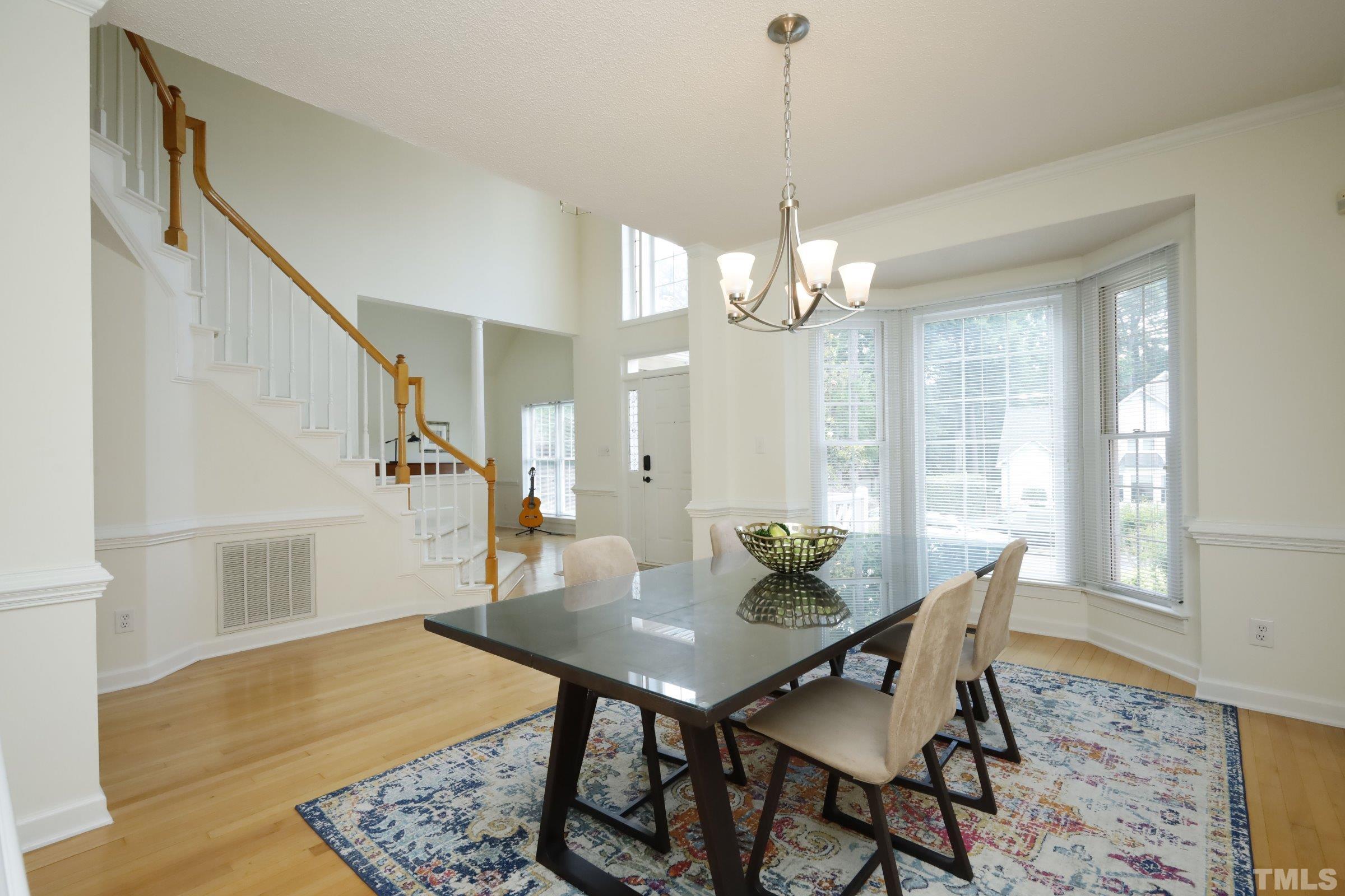 101 Modena Drive Cary, NC 27513 - Photo 10 of 57 a view of a dining room with furniture window and wooden floor