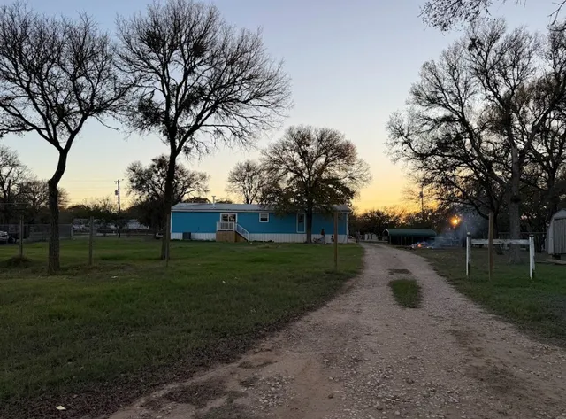 a view of a house with a backyard