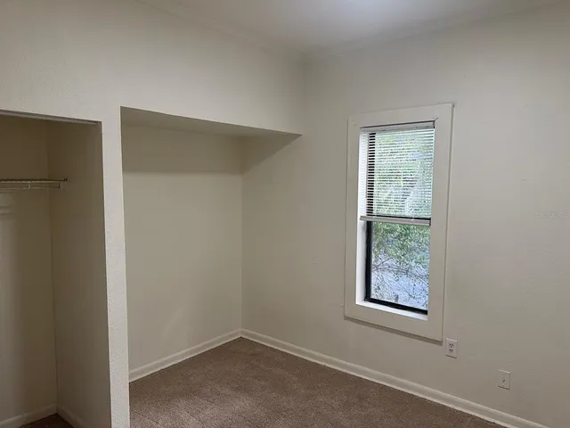 an empty room with closet area