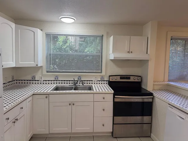 a kitchen with a white cabinets and white appliances
