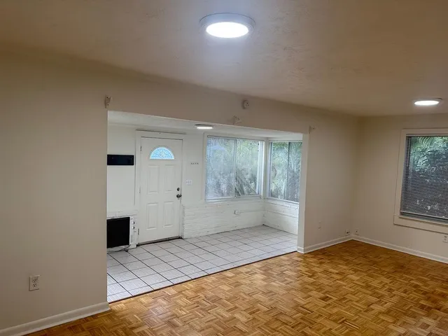 an empty room with windows and entrance