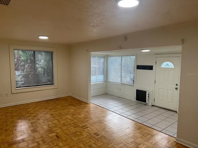a view of an empty room with window and a rug