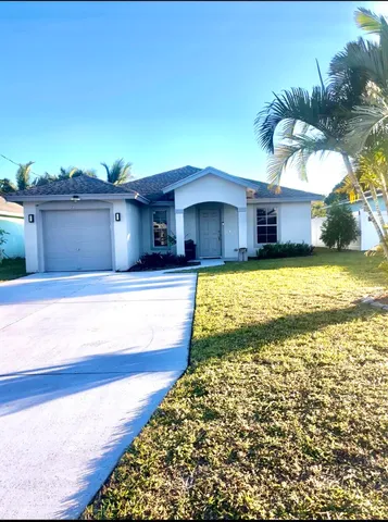 a swimming pool in front of the house
