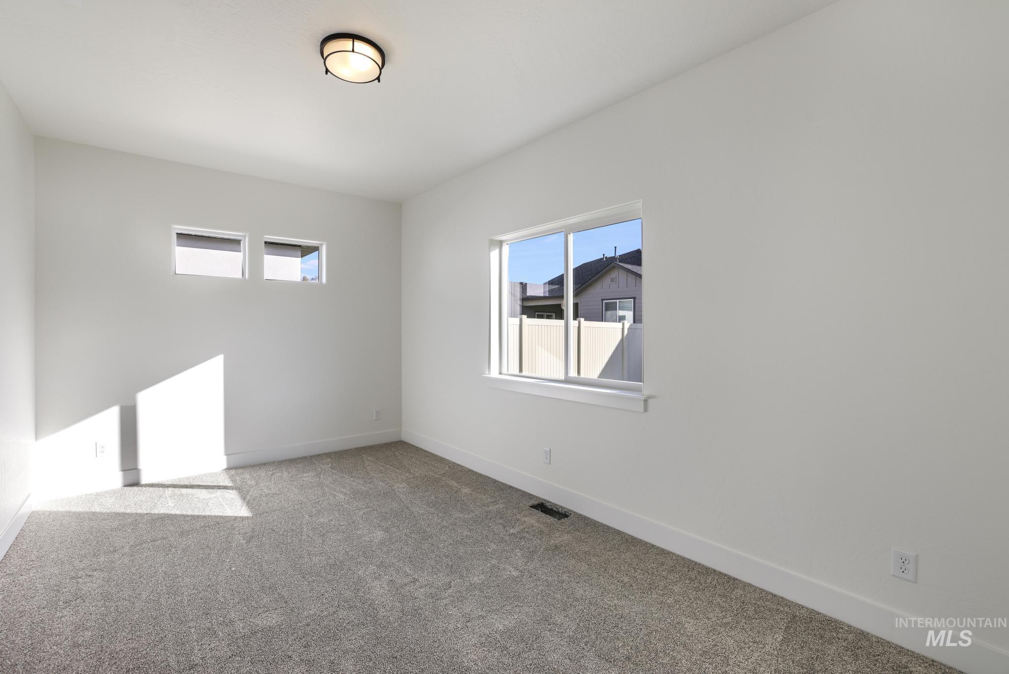 921 Adamite Road Kimberly, ID 83341 - Photo 21 of 25 Empty room with light colored carpet and baseboards
