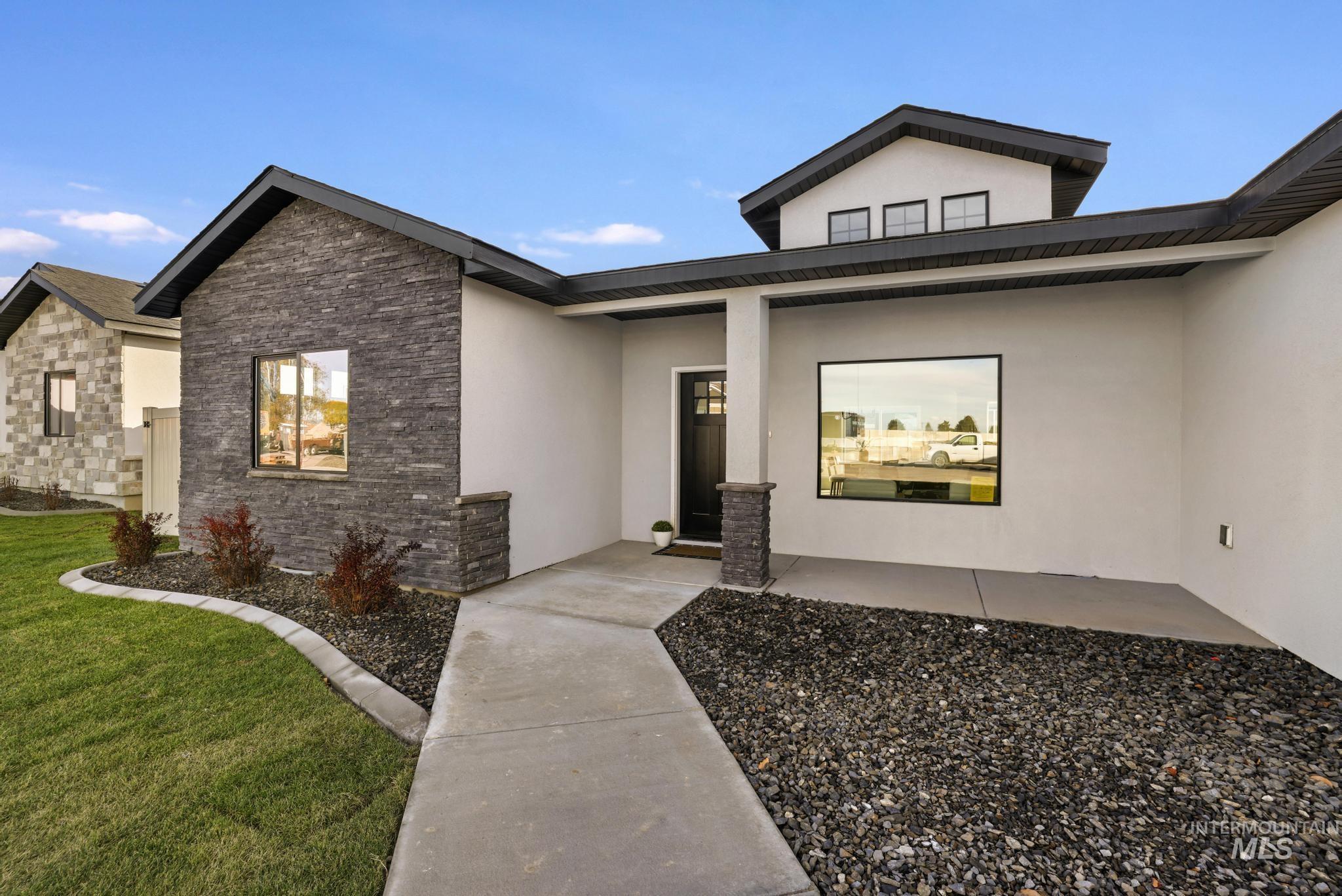 921 Adamite Road Kimberly, ID 83341 - Photo 5 of 25 View of front of home with stone siding, stucco siding, and a front yard