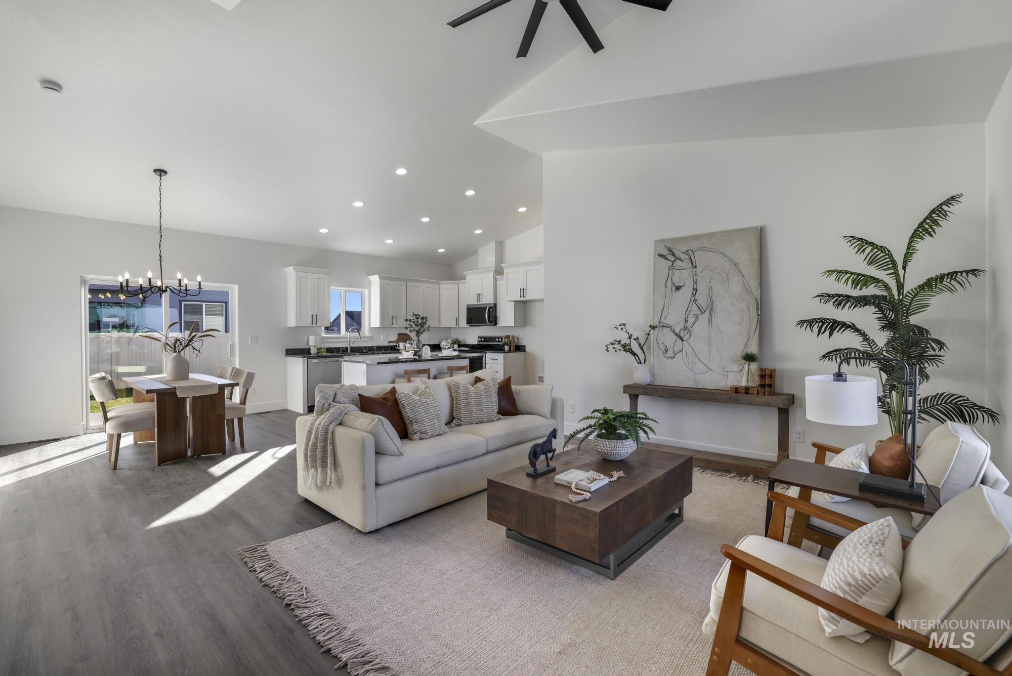 921 Adamite Road Kimberly, ID 83341 - Photo 7 of 25 Living area with wood finished floors, recessed lighting, a chandelier, a ceiling fan, and high vaulted ceiling