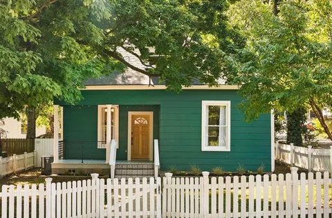 a front view of a house with a small yard