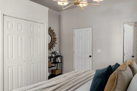 a bed sitting in a bedroom next to a window