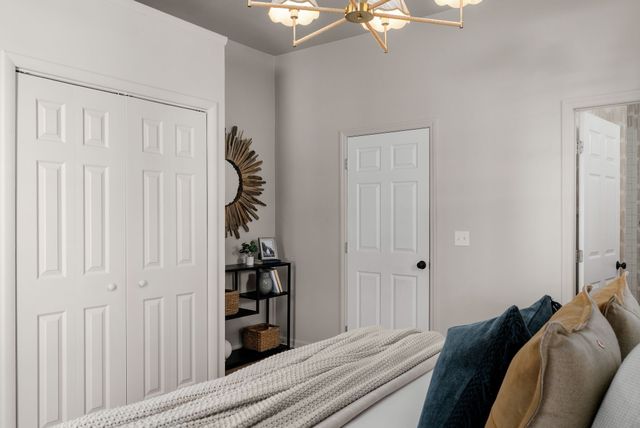 a bed sitting in a bedroom next to a window