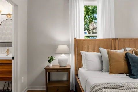 a bathroom with a double vanity sink toilet and a mirror