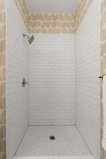 a en suite bathroom with a double vanity sink and a mirror