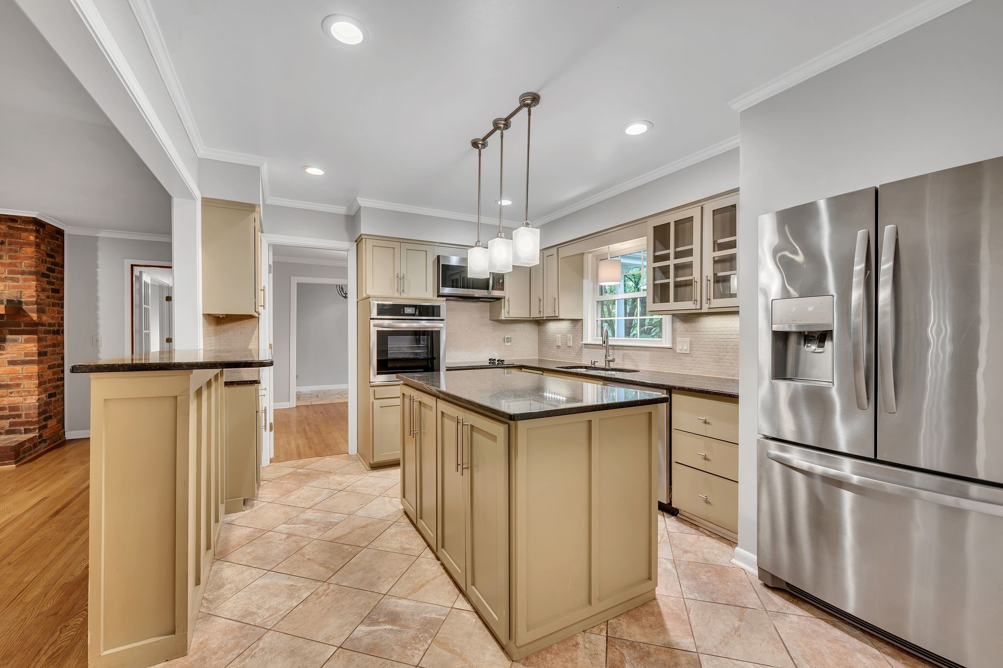 6620 Ellesmere Road Nashville, TN 37205 - Photo 15 of 45 Modern, sleek and fully equipped- this updated kitchen features stainless steel appliances, granite countertops, new lighting, tile flooring and backblash, and a large island for prepping your favorite meals.