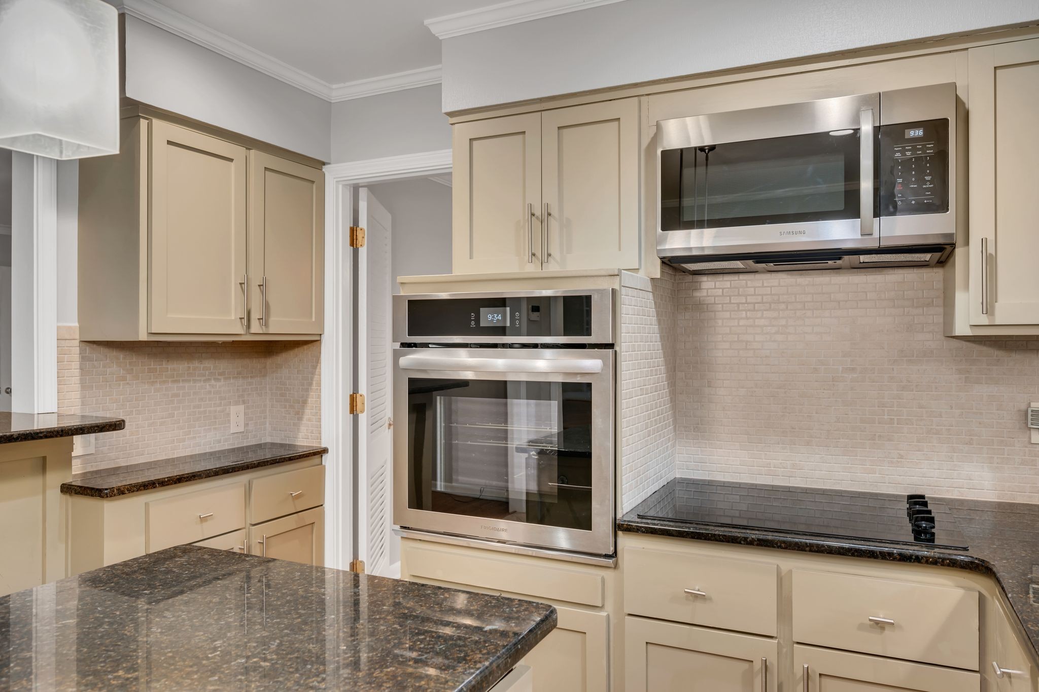 6620 Ellesmere Road Nashville, TN 37205 - Photo 16 of 45 Modern, sleek and fully equipped- this updated kitchen features stainless steel appliances, granite countertops, new lighting, tile flooring and backblash, and a large island for prepping your favorite meals.