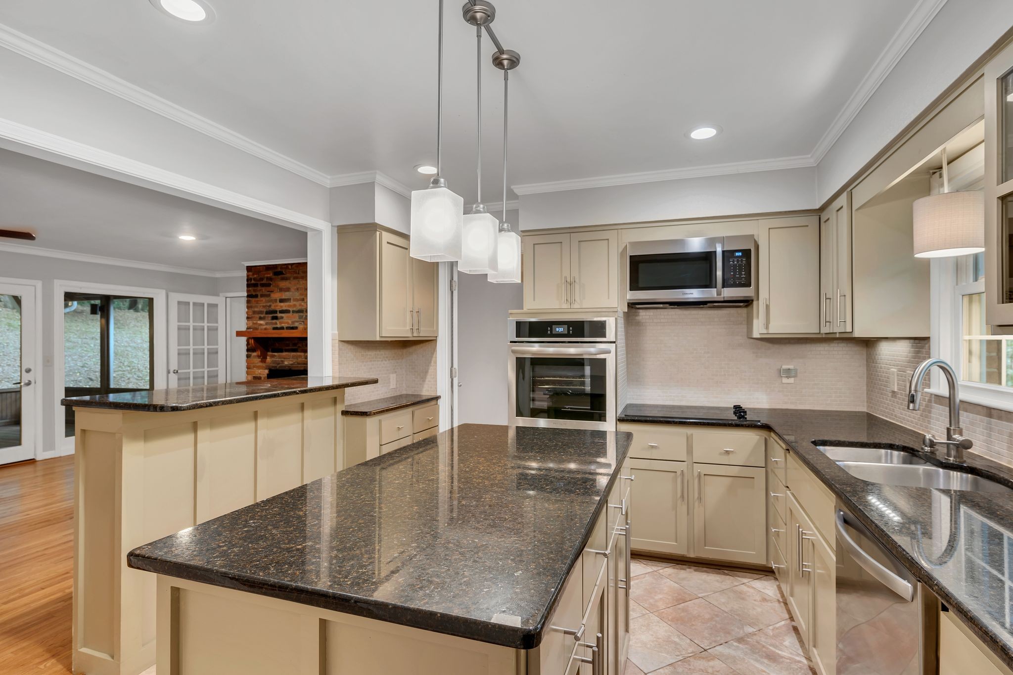 6620 Ellesmere Road Nashville, TN 37205 - Photo 18 of 45 Modern, sleek and fully equipped- this updated kitchen features stainless steel appliances, granite countertops, new lighting, tile flooring and backblash, and a large island for prepping your favorite meals.