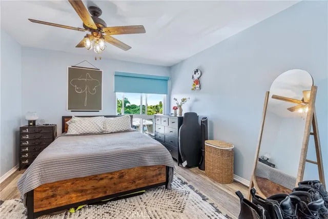 a bedroom with a bed and wooden floor