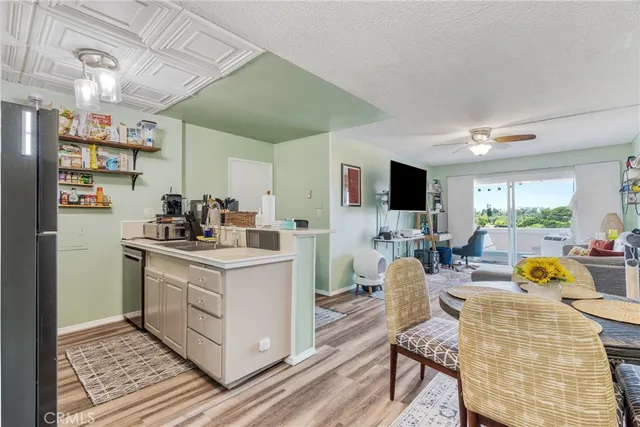 a kitchen with stainless steel appliances kitchen island granite countertop a sink and cabinets