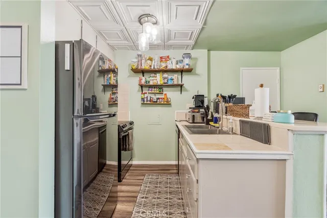 a kitchen with a sink a refrigerator and a stove